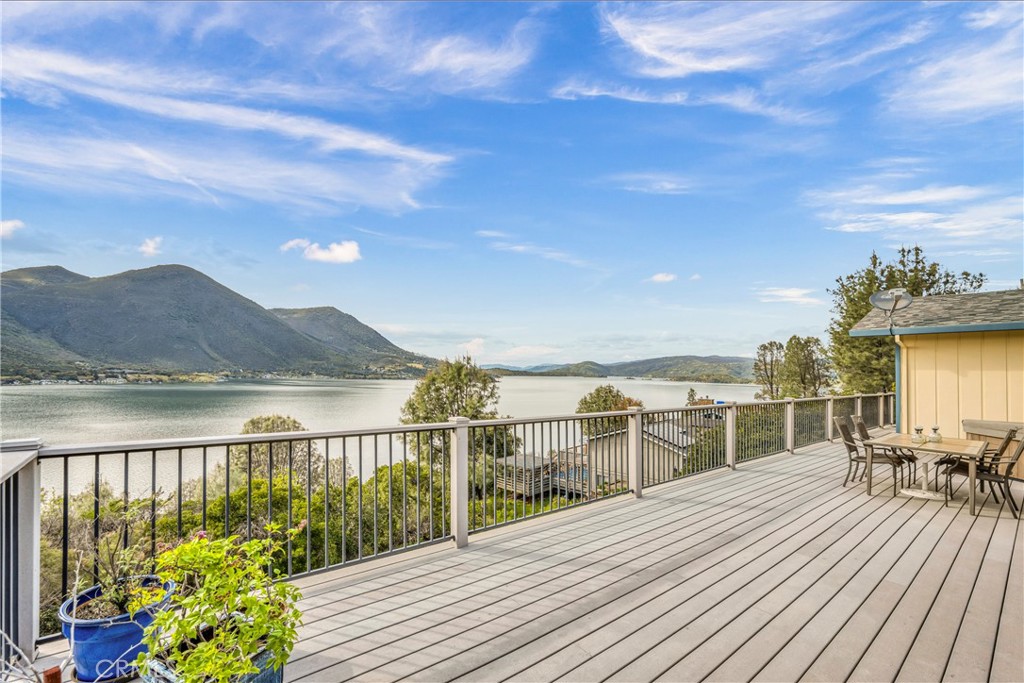 a view of a balcony with wooden floor and lake view