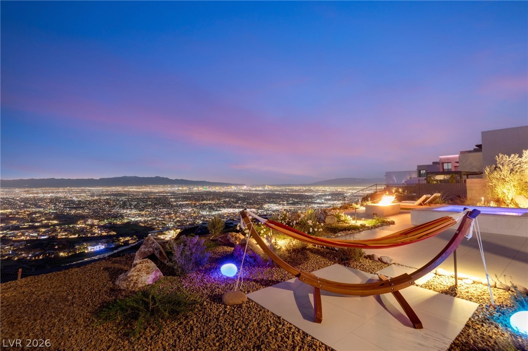 571 Overlook Rim Drive Henderson, NV 89012 - Photo 69 of 85 Patio terrace at dusk featuring an outdoor pool and a mountain view