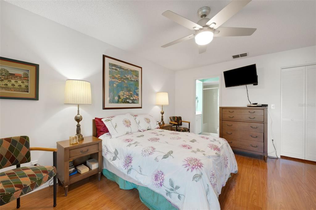 3681 Ridgemont Court Palm Harbor, FL 34684 - Photo 26 of 81 a bedroom with a bed and a chandelier