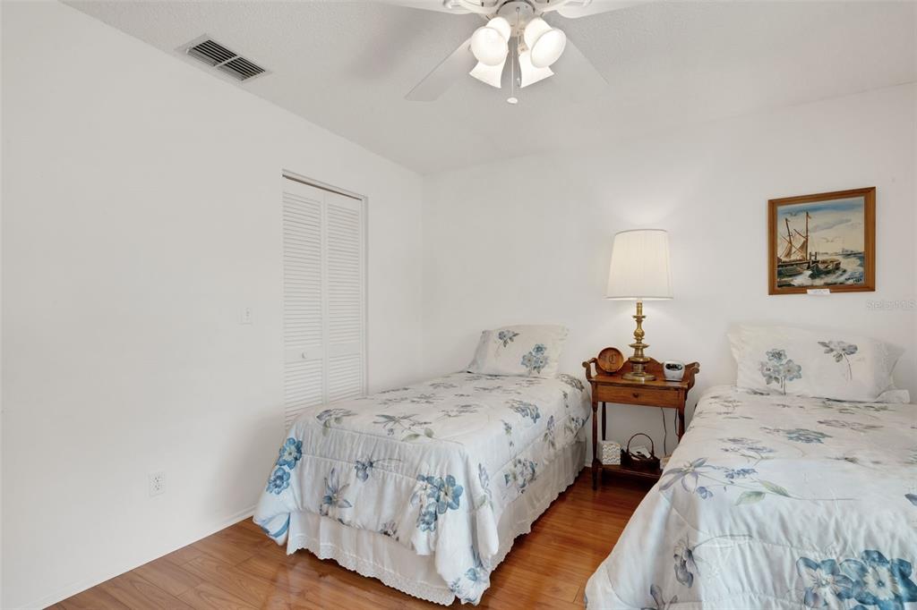3681 Ridgemont Court Palm Harbor, FL 34684 - Photo 34 of 81 a bedroom with a bed and a chandelier