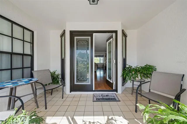 a dining room with furniture a chandelier and window