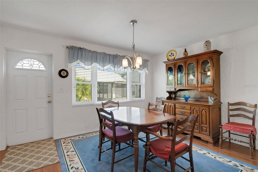 3681 Ridgemont Court Palm Harbor, FL 34684 - Photo 9 of 81 a dining room with furniture a rug and a chandelier