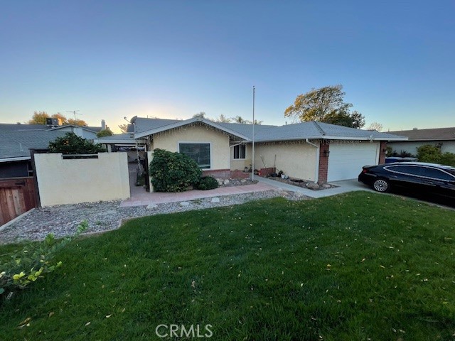 a front view of a house with a garden and plants
