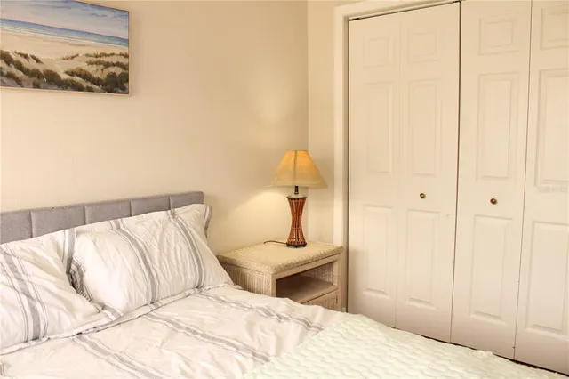 a bedroom with a bed and lamp