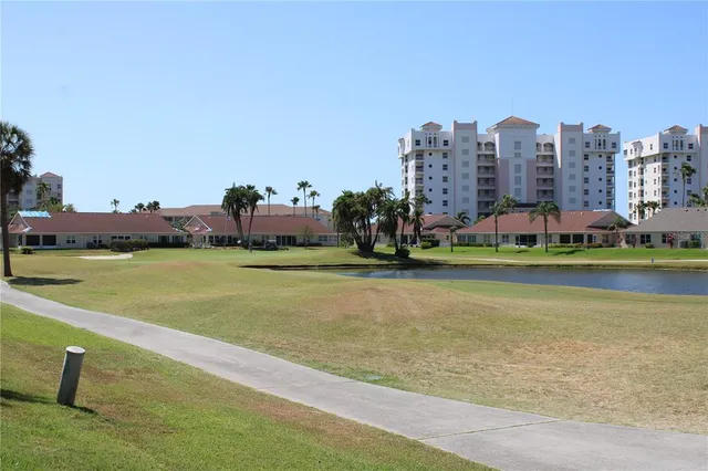 a view of a city with tall buildings and a big yard