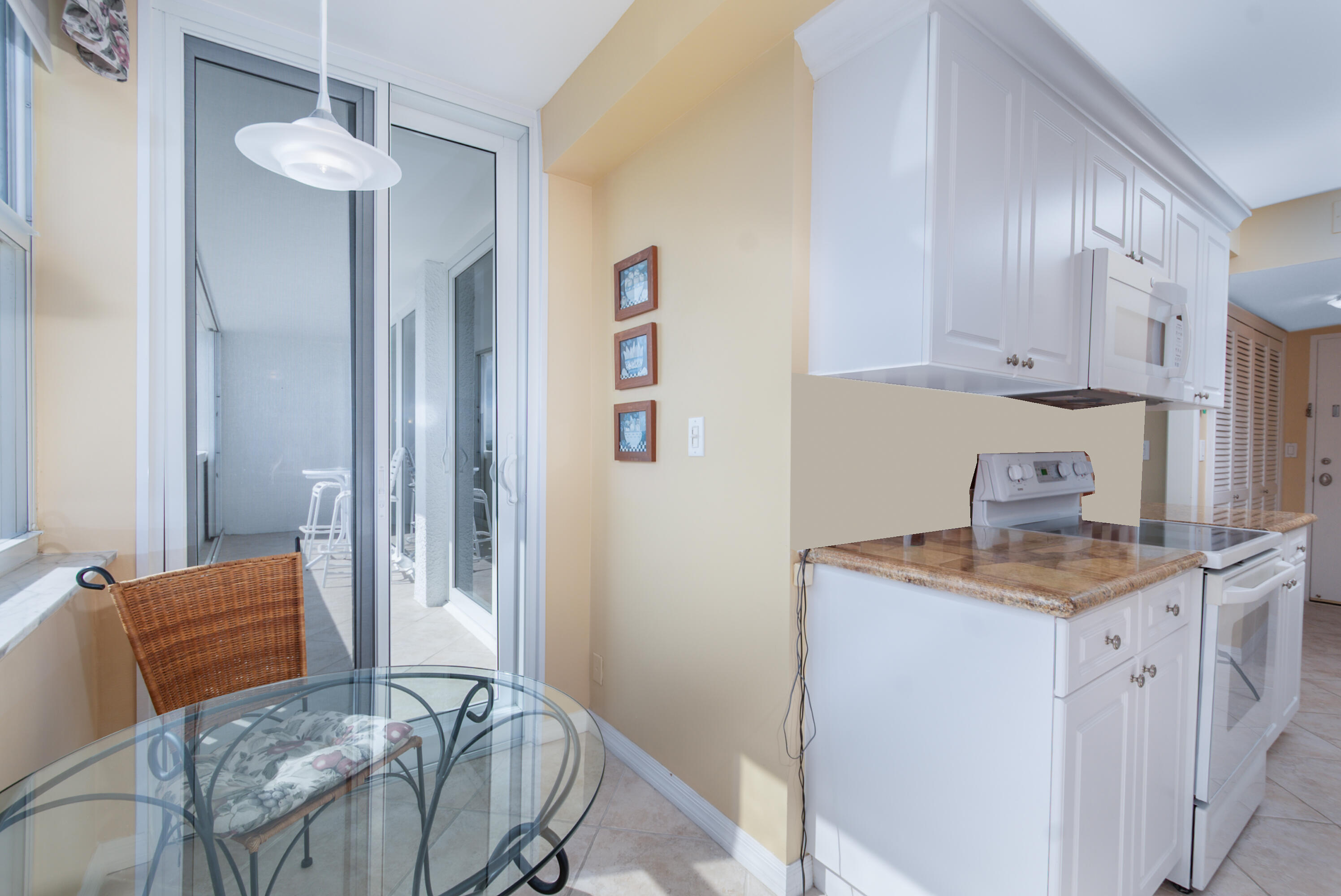 1200 South Ocean Boulevard, Unit 11D Boca Raton, FL 33432 - Photo 12 of 45 a kitchen with stainless steel appliances granite countertop a sink and a refrigerator
