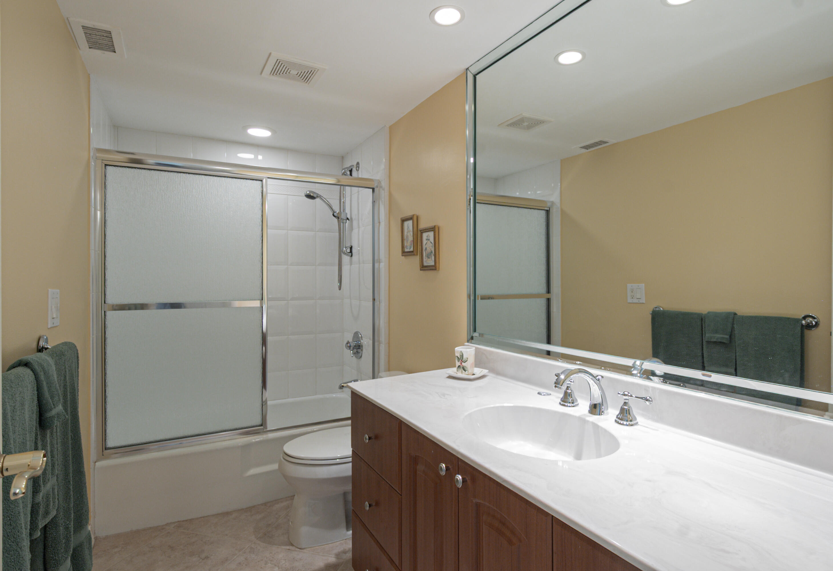1200 South Ocean Boulevard, Unit 11D Boca Raton, FL 33432 - Photo 10 of 45 a bathroom with a double vanity sink toilet mirror and shower