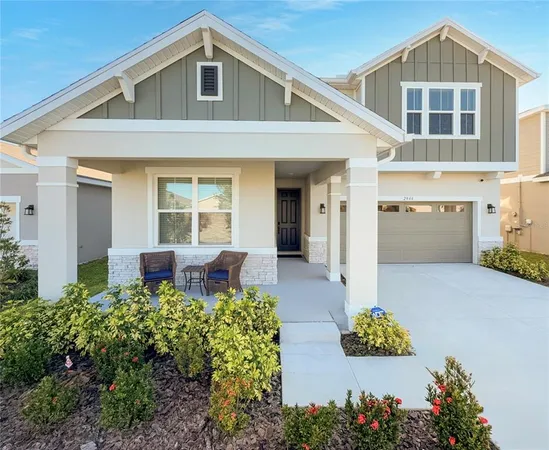 a front view of a house with a yard and outdoor seating
