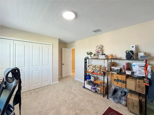 a view of a walk in closet and bathroom