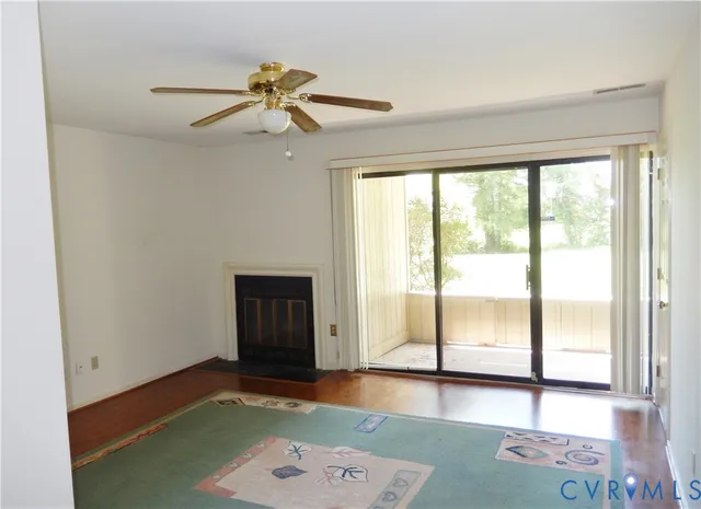 a view of a livingroom with a ceiling fan and window