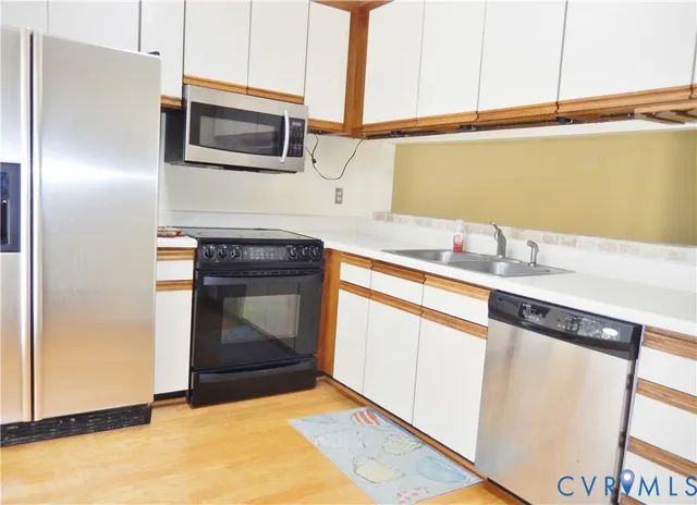 a kitchen with granite countertop a sink stove and microwave