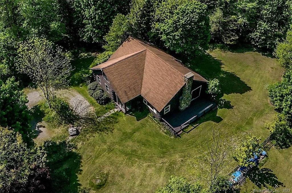 an aerial view of a house with yard and lake view