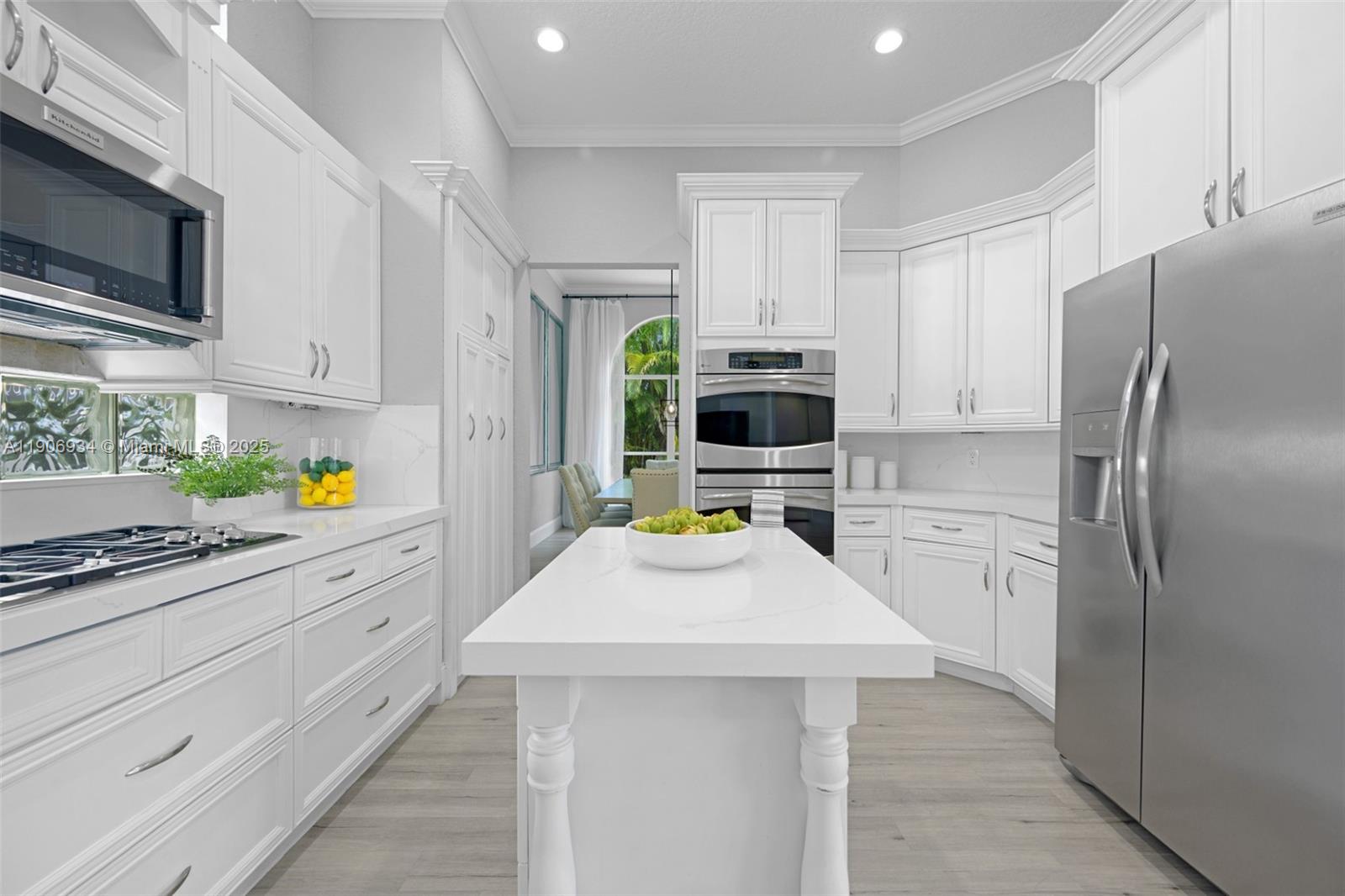 18715 Ocean Mist Drive Boca Raton, FL 33498 - Photo 11 of 44 a kitchen with refrigerator a stove a microwave and cabinets