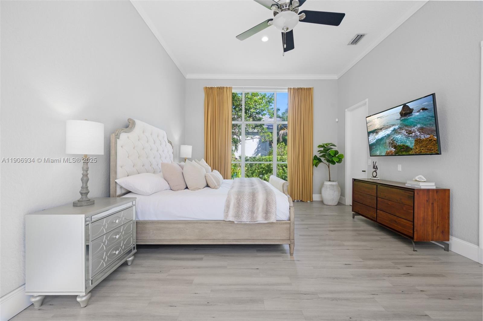 18715 Ocean Mist Drive Boca Raton, FL 33498 - Photo 16 of 44 a spacious bedroom with a bed and a dresser