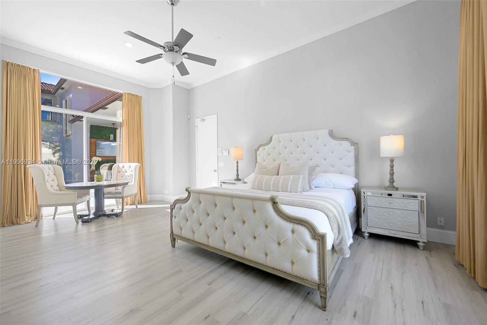 18715 Ocean Mist Drive Boca Raton, FL 33498 - Photo 17 of 44 a bedroom with bed and a chandelier