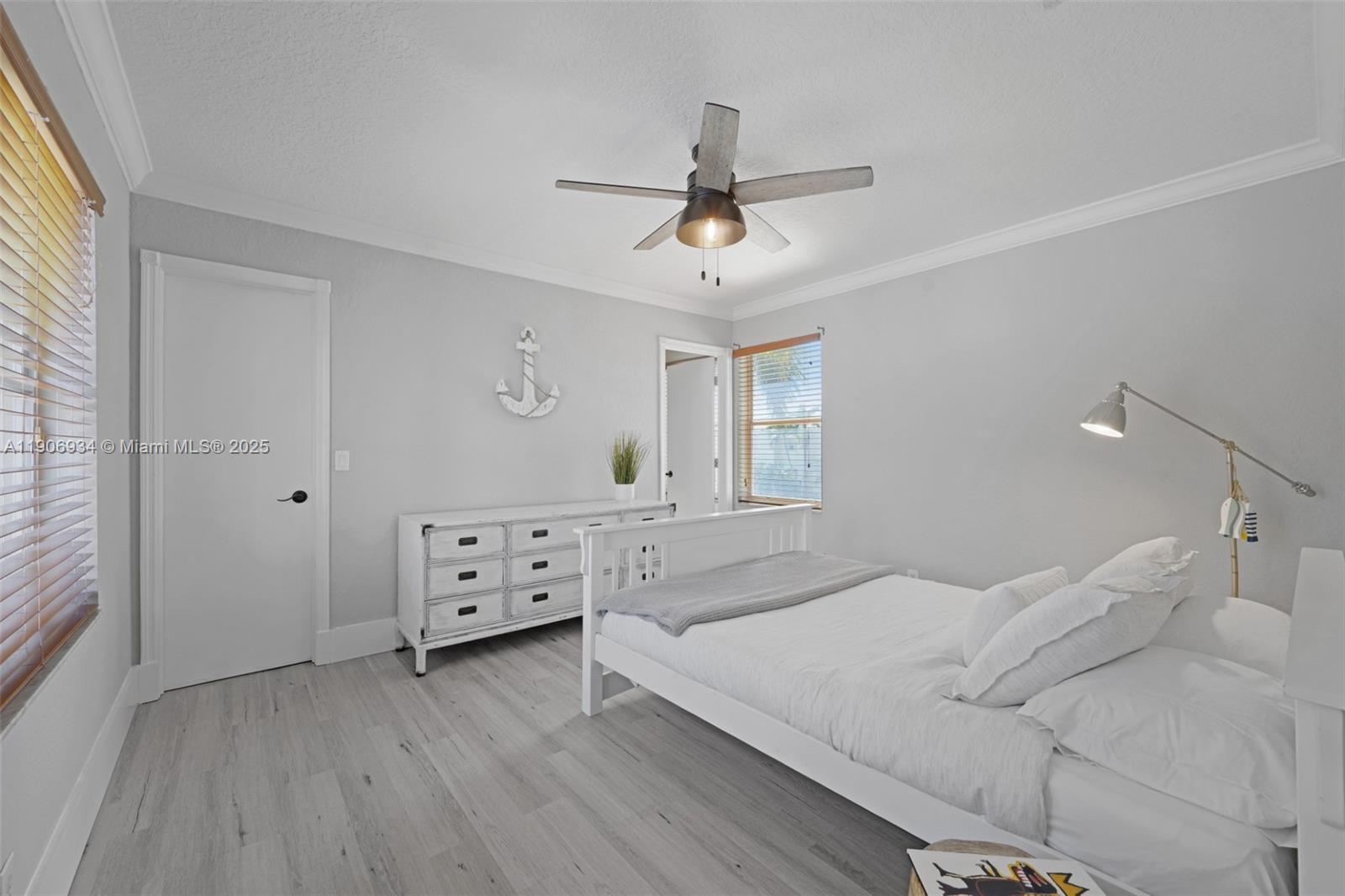 18715 Ocean Mist Drive Boca Raton, FL 33498 - Photo 21 of 44 a bedroom with a bed and a chandelier