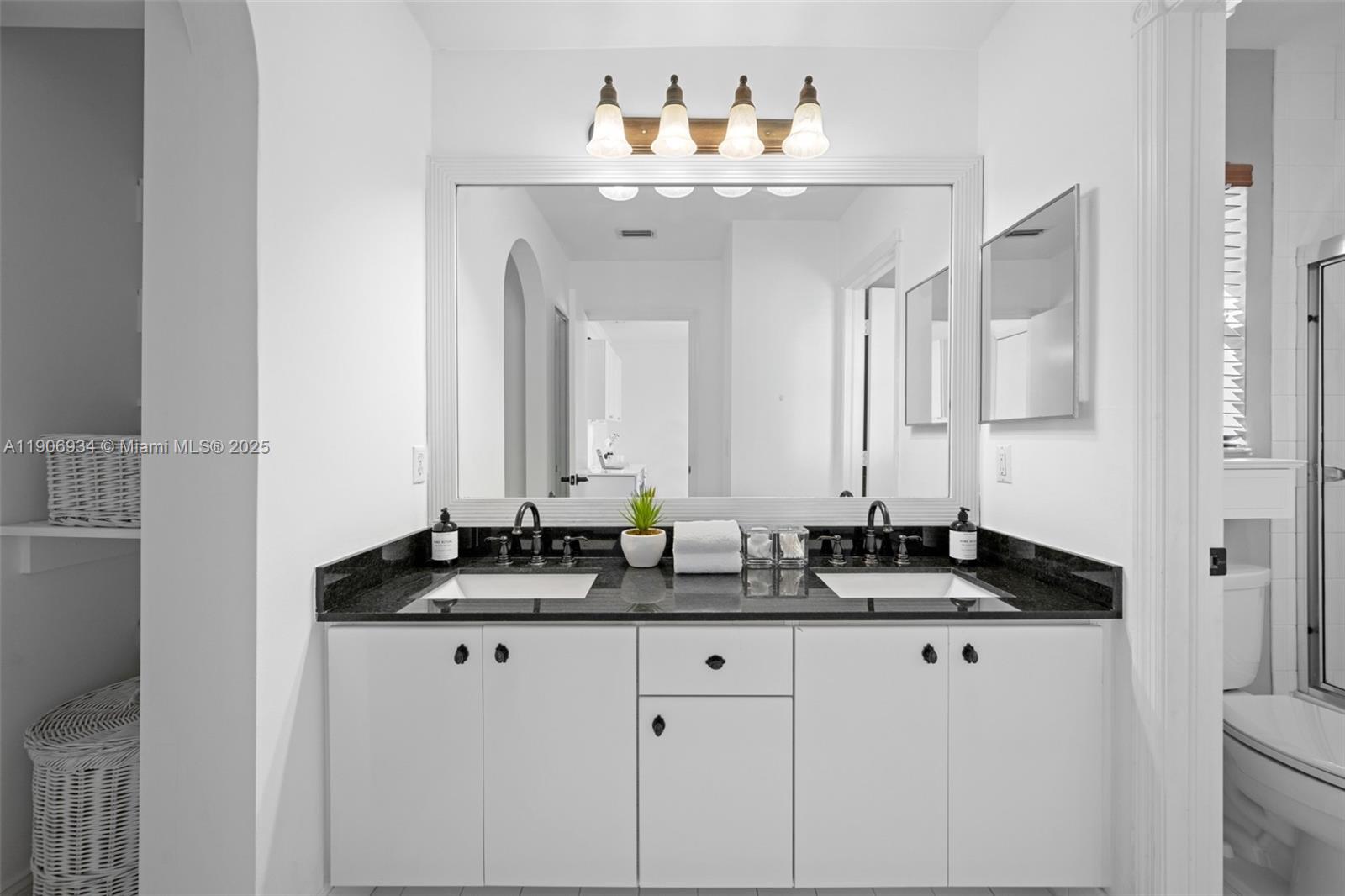 18715 Ocean Mist Drive Boca Raton, FL 33498 - Photo 24 of 44 a bathroom with a sink and a mirror