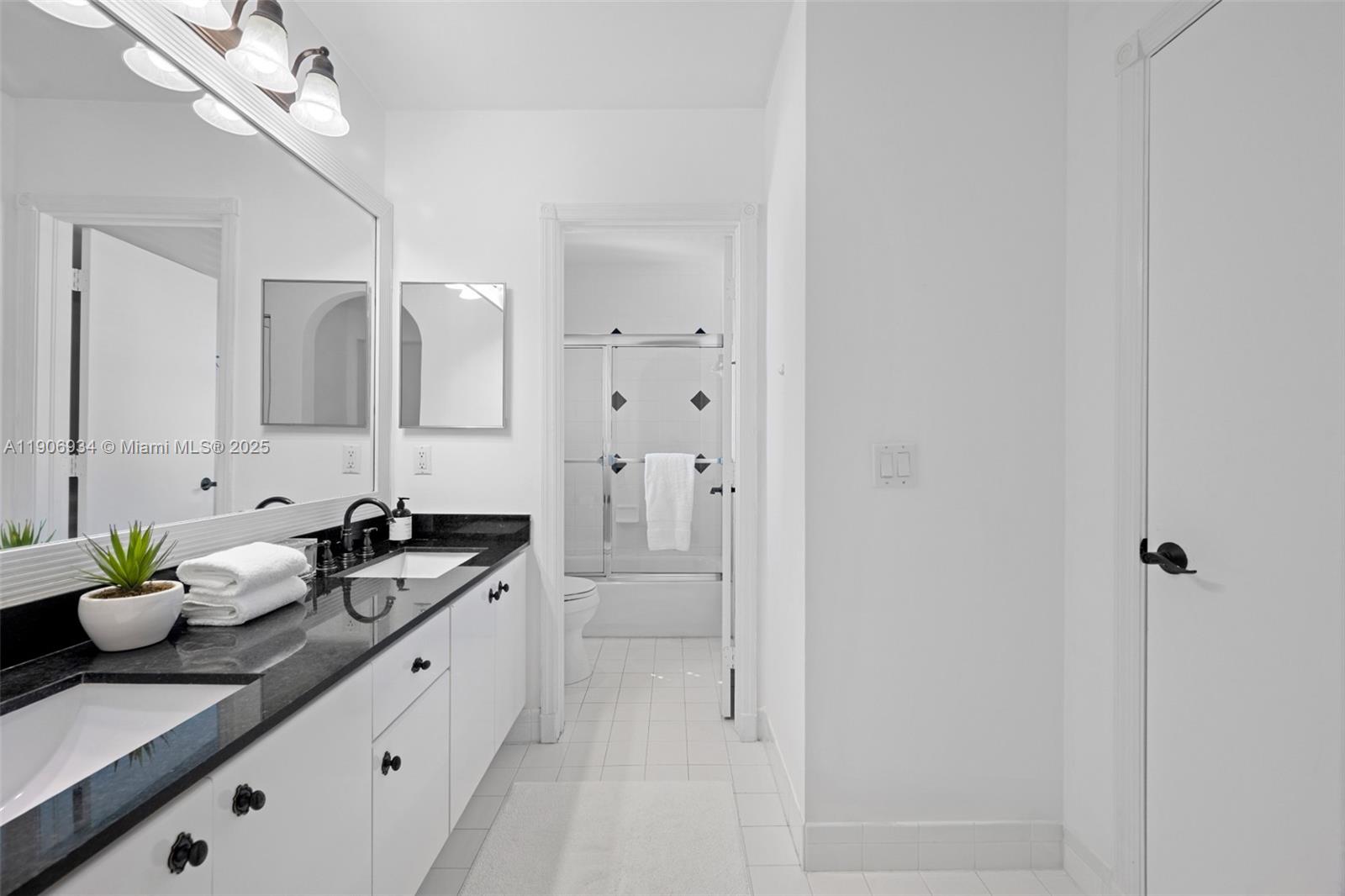 18715 Ocean Mist Drive Boca Raton, FL 33498 - Photo 25 of 44 a bathroom with a granite countertop sink a toilet and a mirror