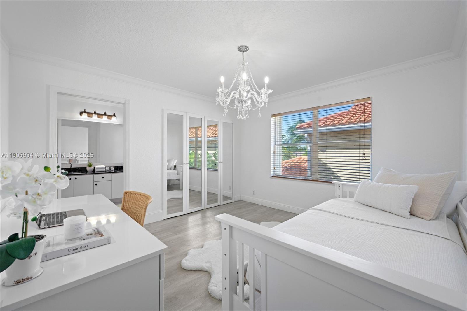 18715 Ocean Mist Drive Boca Raton, FL 33498 - Photo 26 of 44 a bedroom with a large bed a chandelier and window