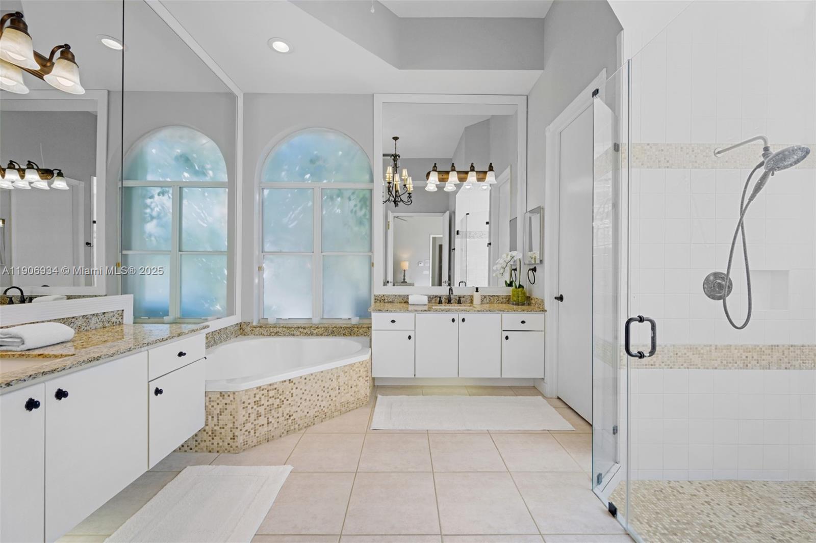 18715 Ocean Mist Drive Boca Raton, FL 33498 - Photo 29 of 44 a large spacious bathroom with a granite countertop tub sink and mirror