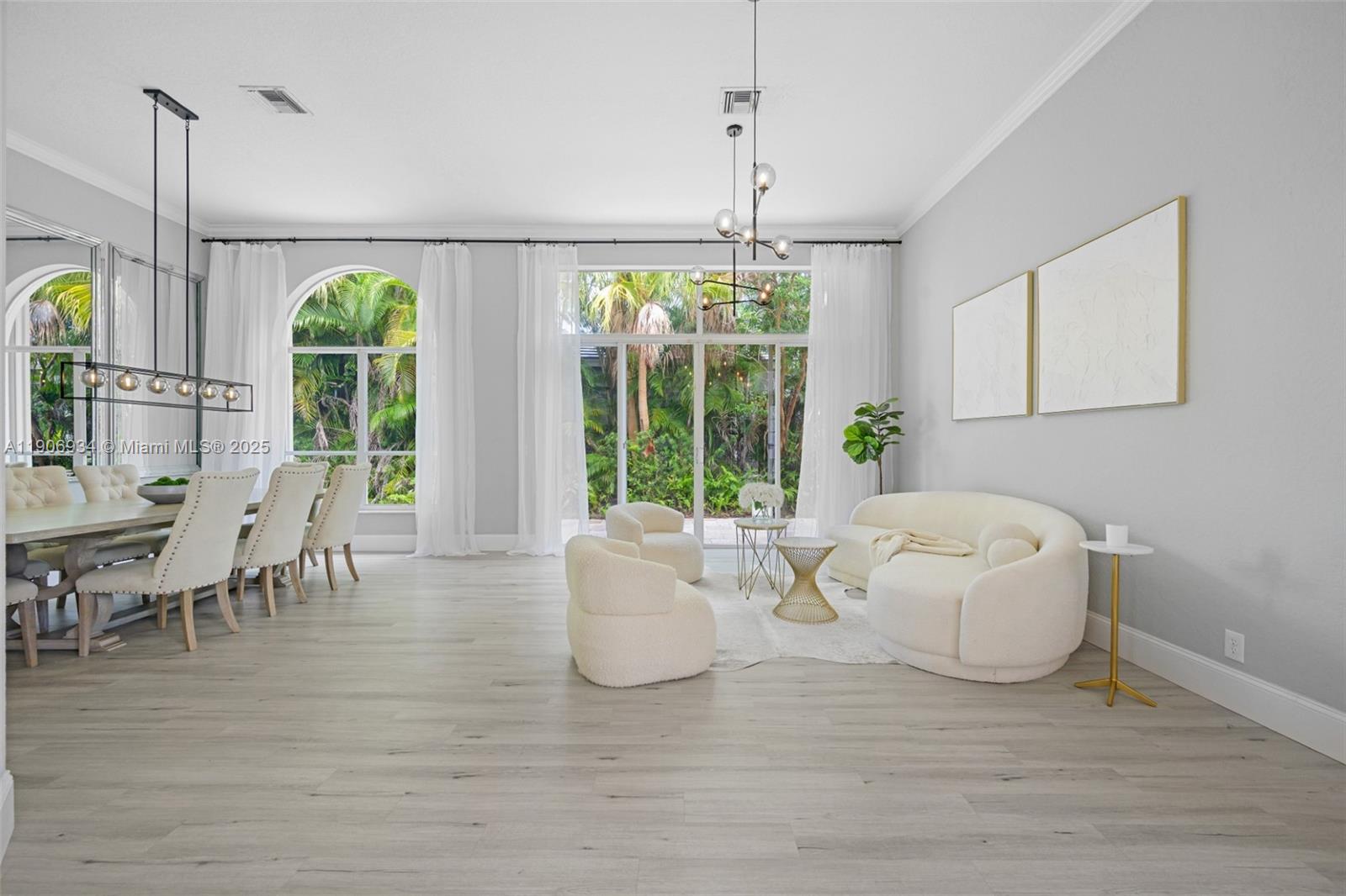 18715 Ocean Mist Drive Boca Raton, FL 33498 - Photo 5 of 44 a living room with furniture and a chandelier