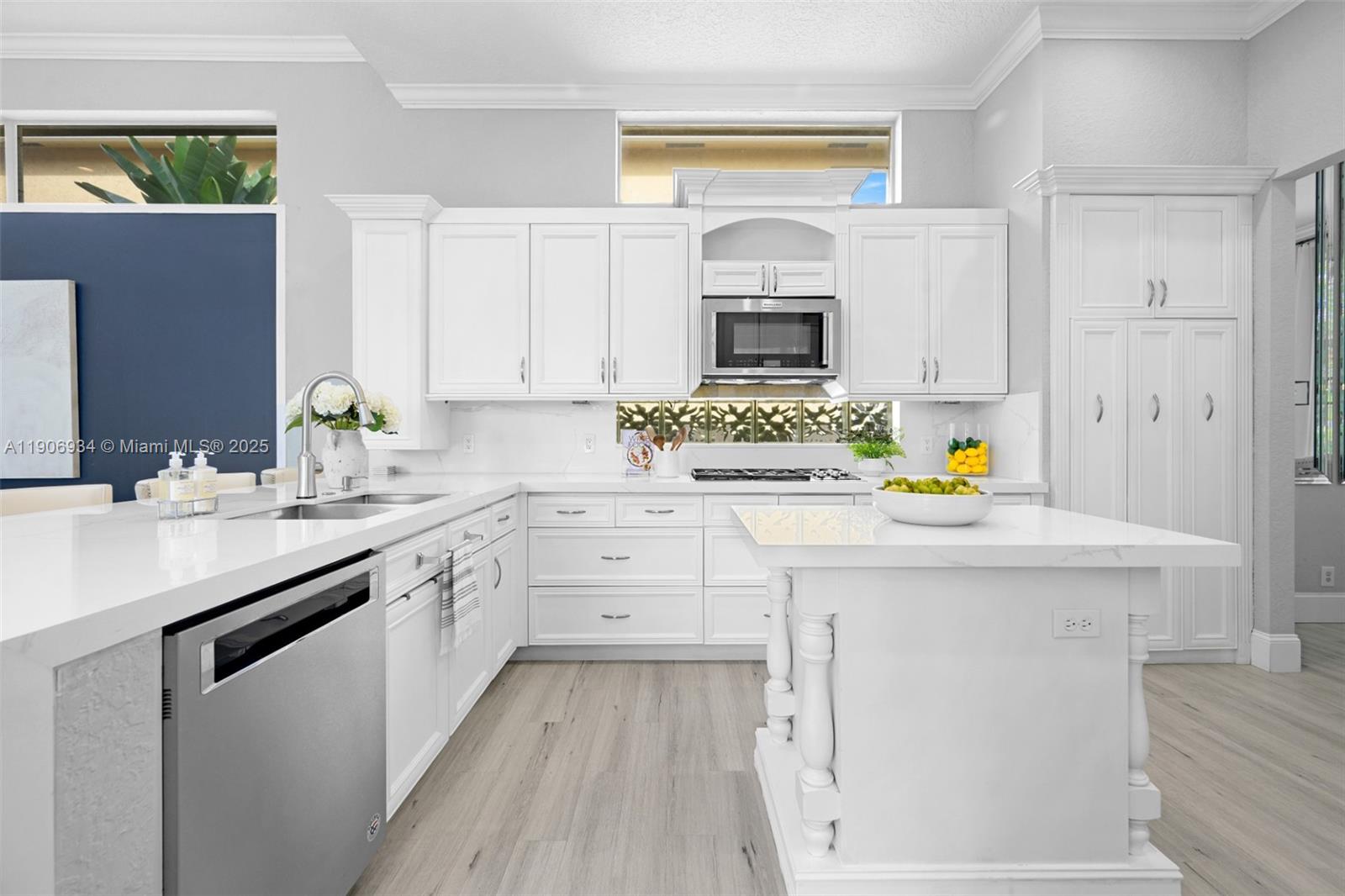 18715 Ocean Mist Drive Boca Raton, FL 33498 - Photo 9 of 44 a kitchen with kitchen island white cabinets appliances and a window