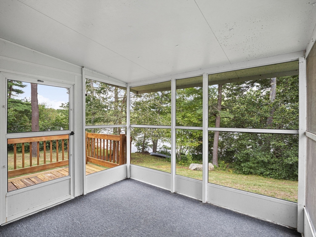 83 Lake Street Acushnet, MA 02743 - Photo 16 of 39 a view of an empty room with wooden floor and windows