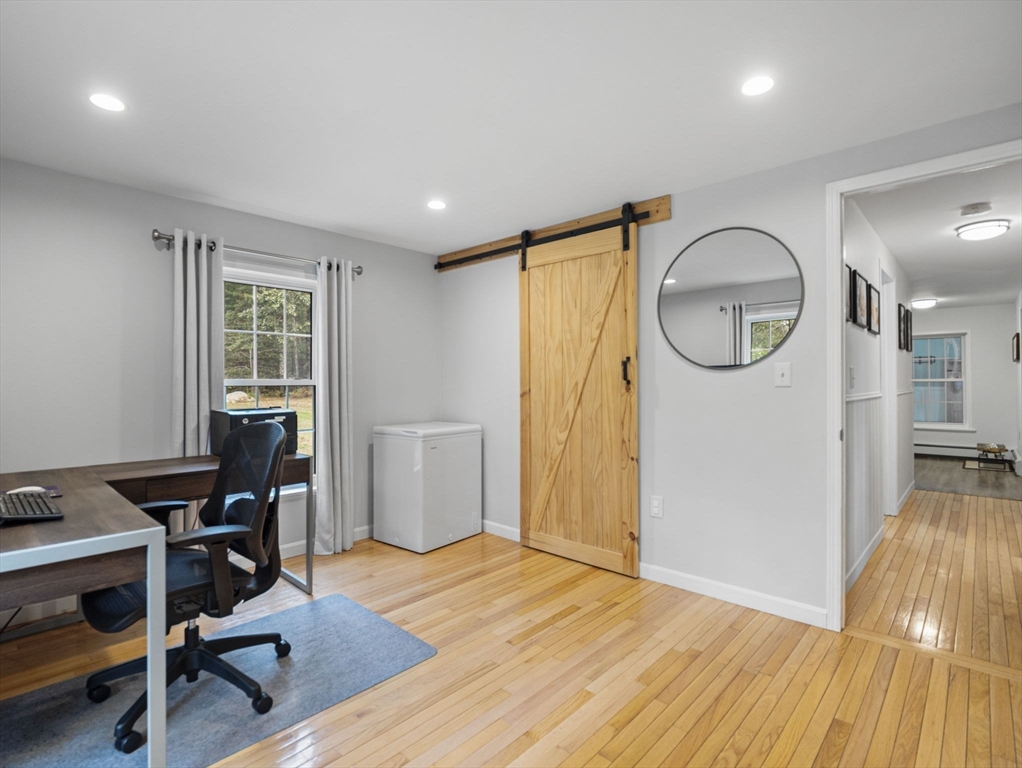83 Lake Street Acushnet, MA 02743 - Photo 21 of 39 a view of a workspace room with wooden floor and windows