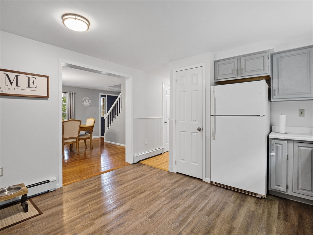 83 Lake Street Acushnet, MA 02743 - Photo 8 of 39 a view of livingroom with hardwood floor and a refrigerator