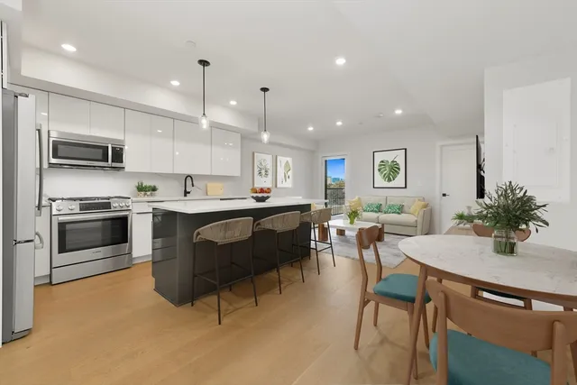 a kitchen with a sink cabinets and stainless steel appliances