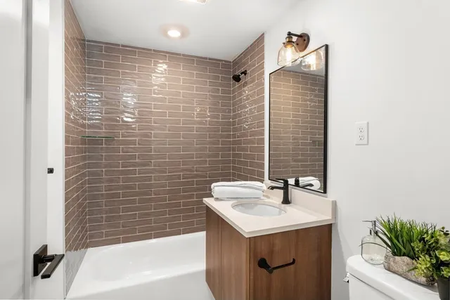 a bathroom with a sink a shower and a mirror