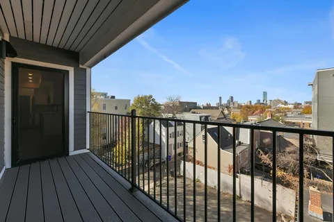 a view of a balcony with wooden floor