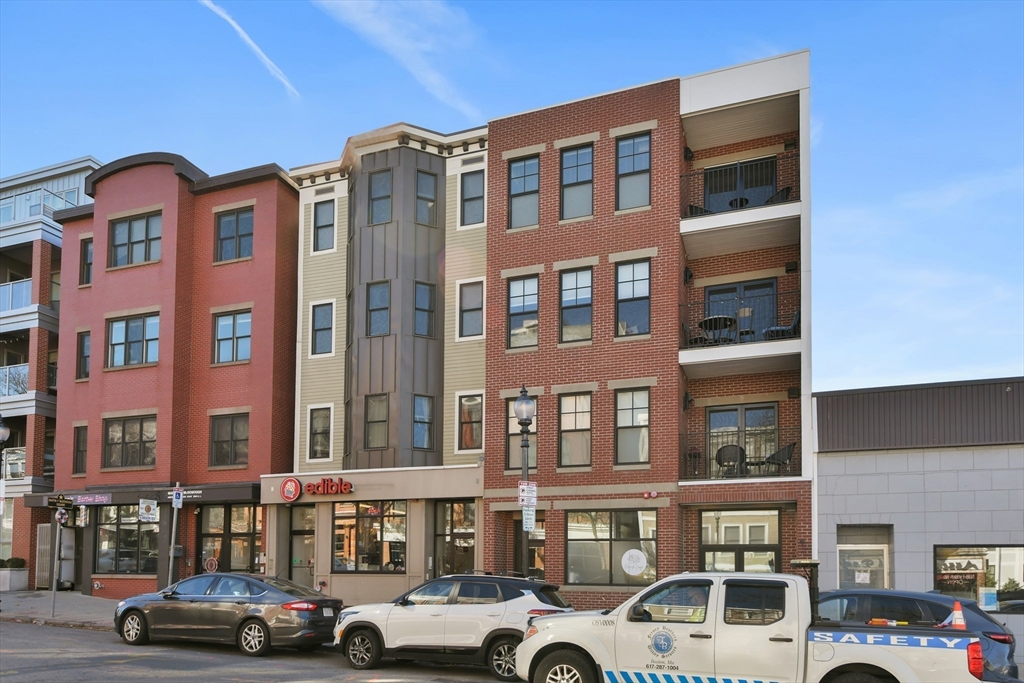 321 West Broadway, Unit 6 Boston, MA 02127 - Photo 16 of 20 a front view of building with lot of cars and trees
