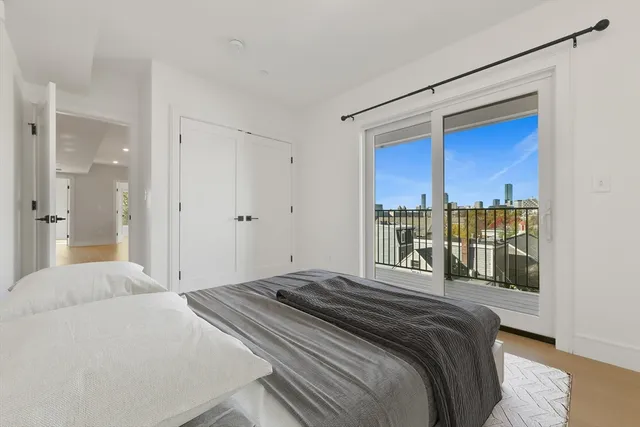 a bedroom with a large bed and a balcony view