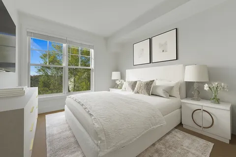 a spacious bedroom with a bed and window