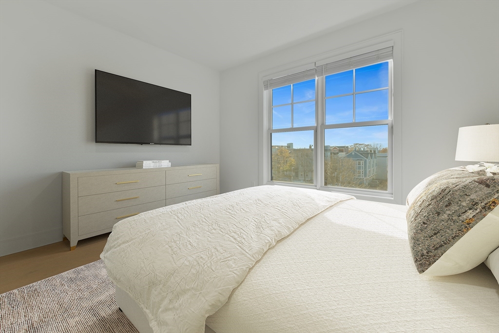 321 West Broadway, Unit 6 Boston, MA 02127 - Photo 10 of 20 a bedroom with a bed and a flat screen tv