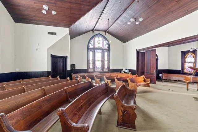 a spacious bathroom with a large window and a ceiling fan