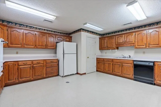 a open kitchen with stainless steel appliances granite countertop a stove sink and cabinets