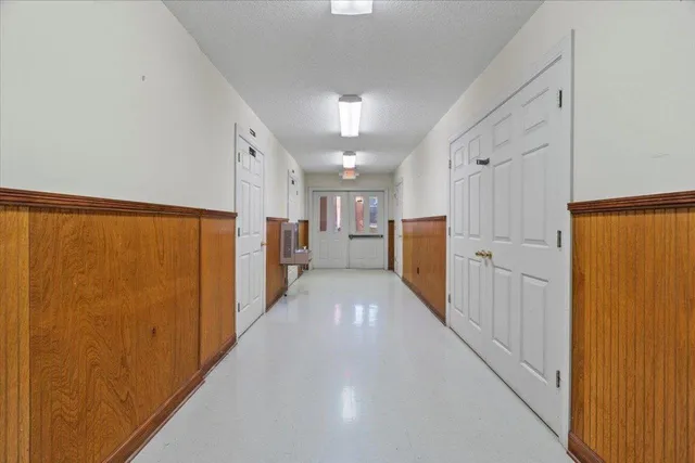 a view of a refrigerator in kitchen and white cabinets