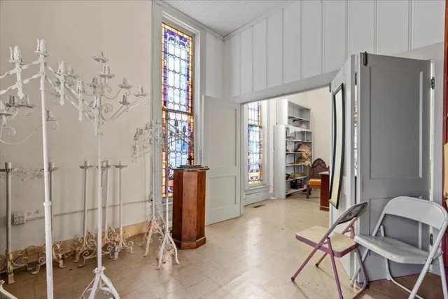 a view of a room that has a table and chairs in it