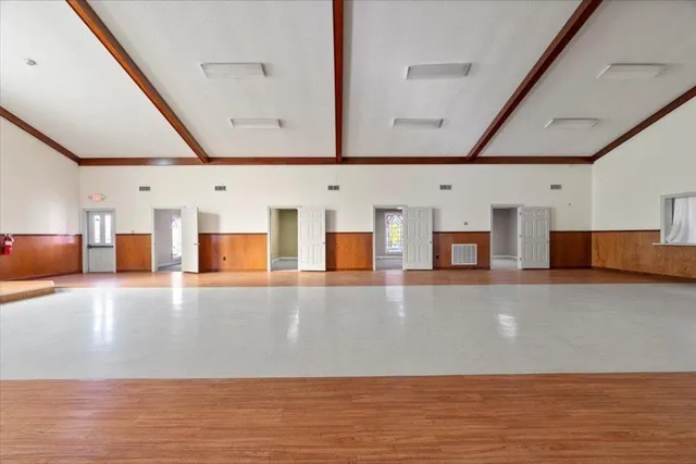 a view of a room with wooden floor