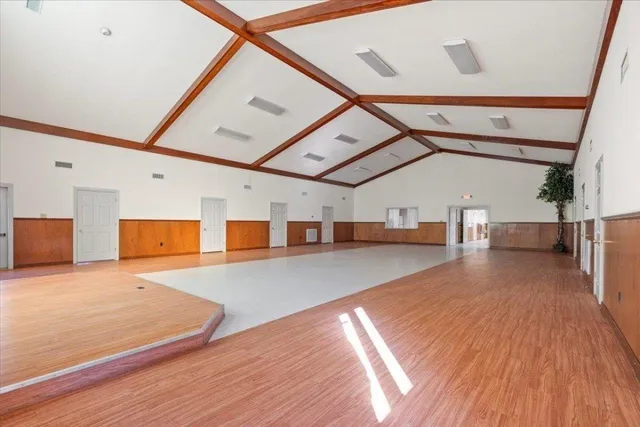 a living room with furniture a fireplace and a chandelier