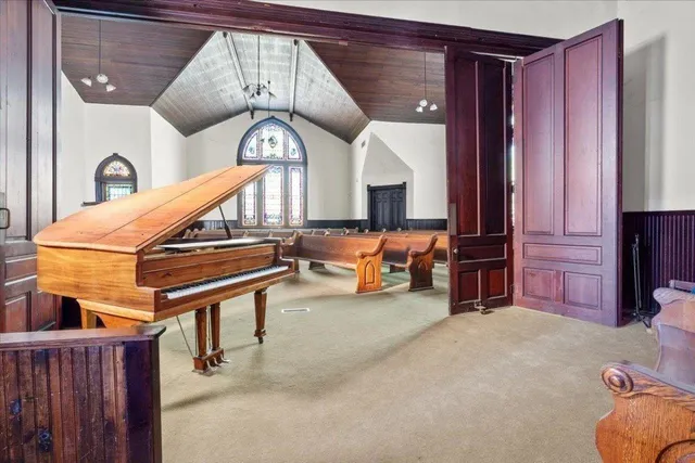 a living room with furniture chandelier and a clock