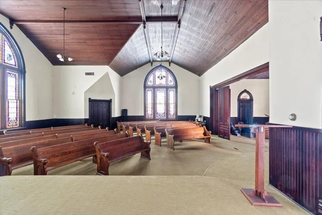 a room with lots of chairs and mirrors