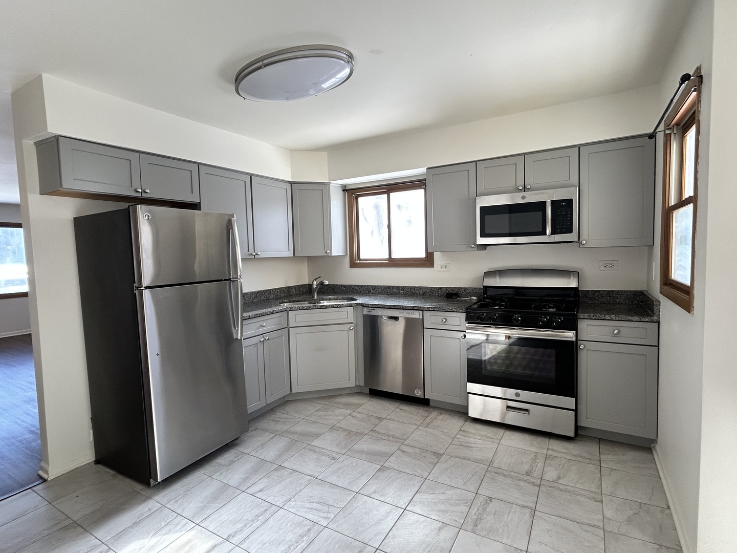 422 Lincoln Avenue, Unit A Fox River Grove, IL 60021 - Photo 4 of 15 a kitchen with a refrigerator sink and microwave