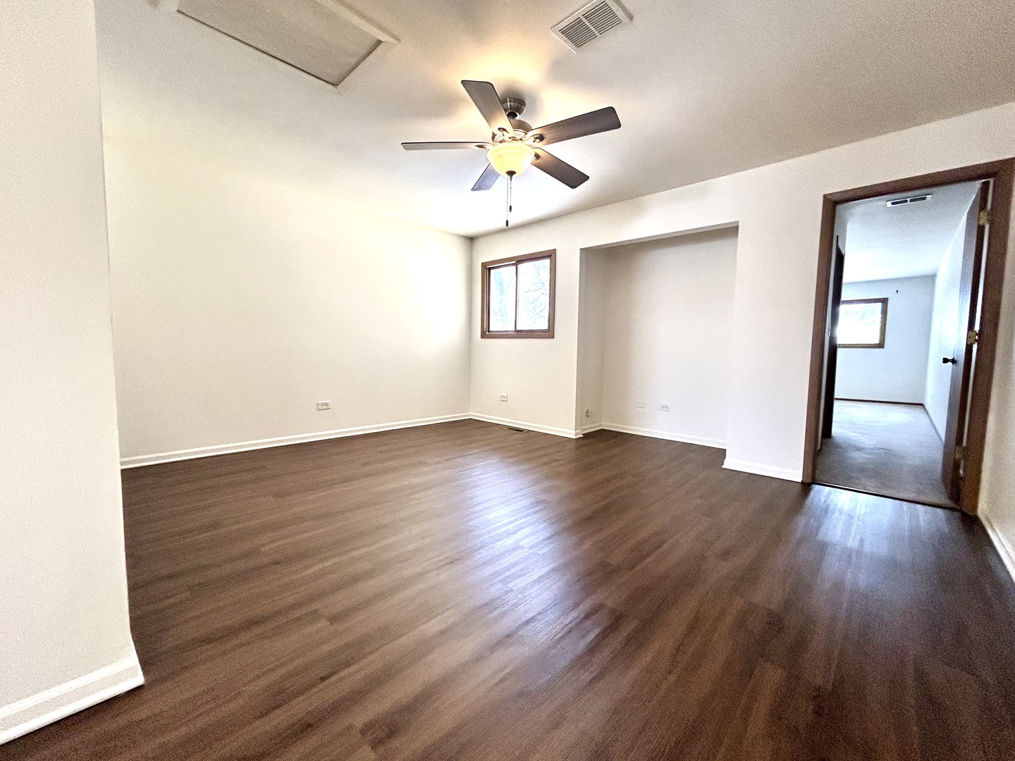 422 Lincoln Avenue, Unit A Fox River Grove, IL 60021 - Photo 7 of 15 a view of an empty room with wooden floor and a ceiling fan