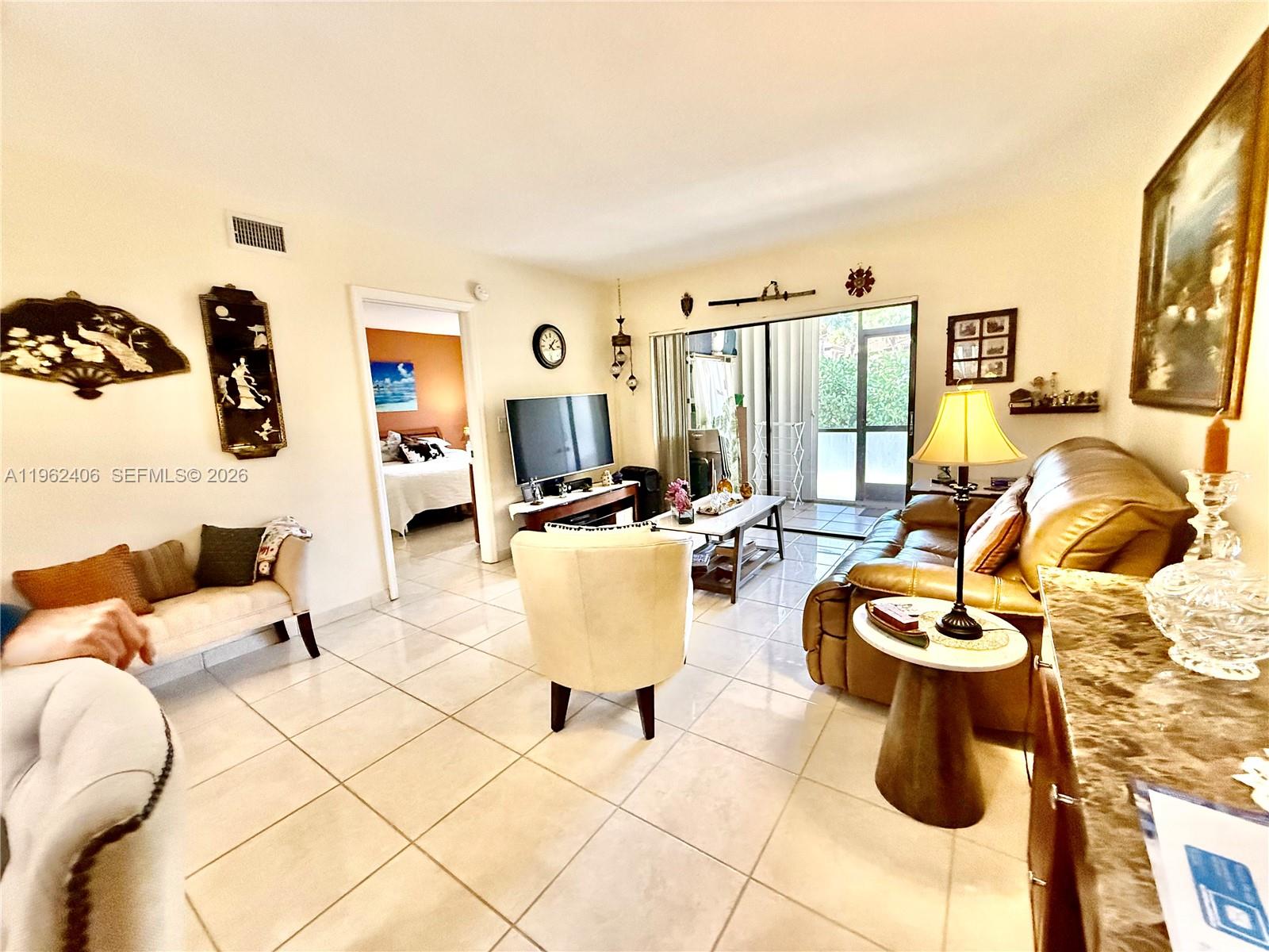 351 Club Circle, Unit 102 Boca Raton, FL 33487 - Photo 16 of 34 a living room with furniture a rug and white walls