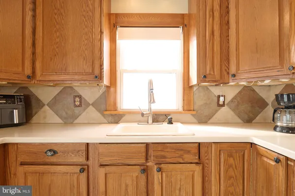 a kitchen with a sink cabinets and a window