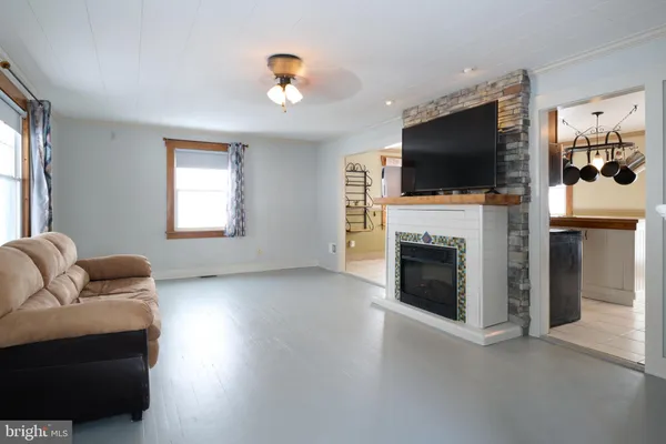 a living room with furniture fireplace and flat screen tv