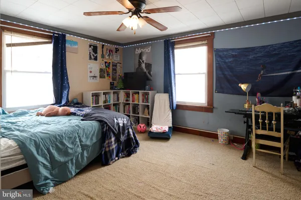 a bed room with a bed and a book shelf